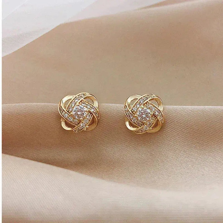 Boucles d'oreilles clous spirales dorées à fleurs de cristal