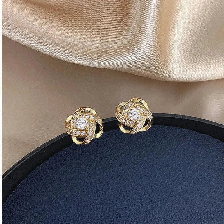 Boucles d'oreilles clous spirales dorées à fleurs de cristal