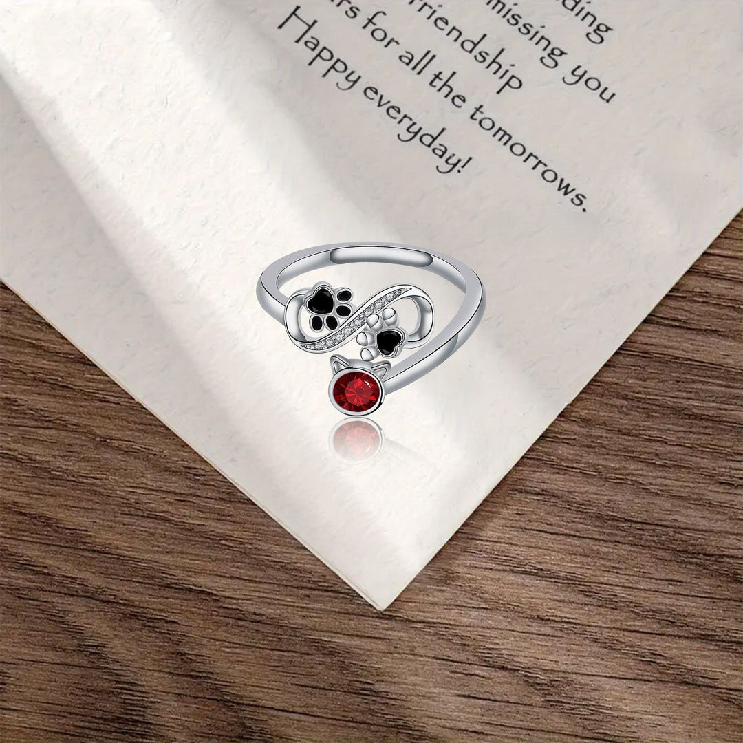 Schwarzer Pfotenabdruck verstellbarer Ring mit roter Gemme